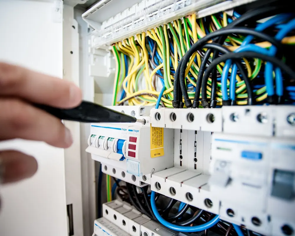 Electrician working on a circuit breaker panel during electrical service in Terrell TX (stock photo)