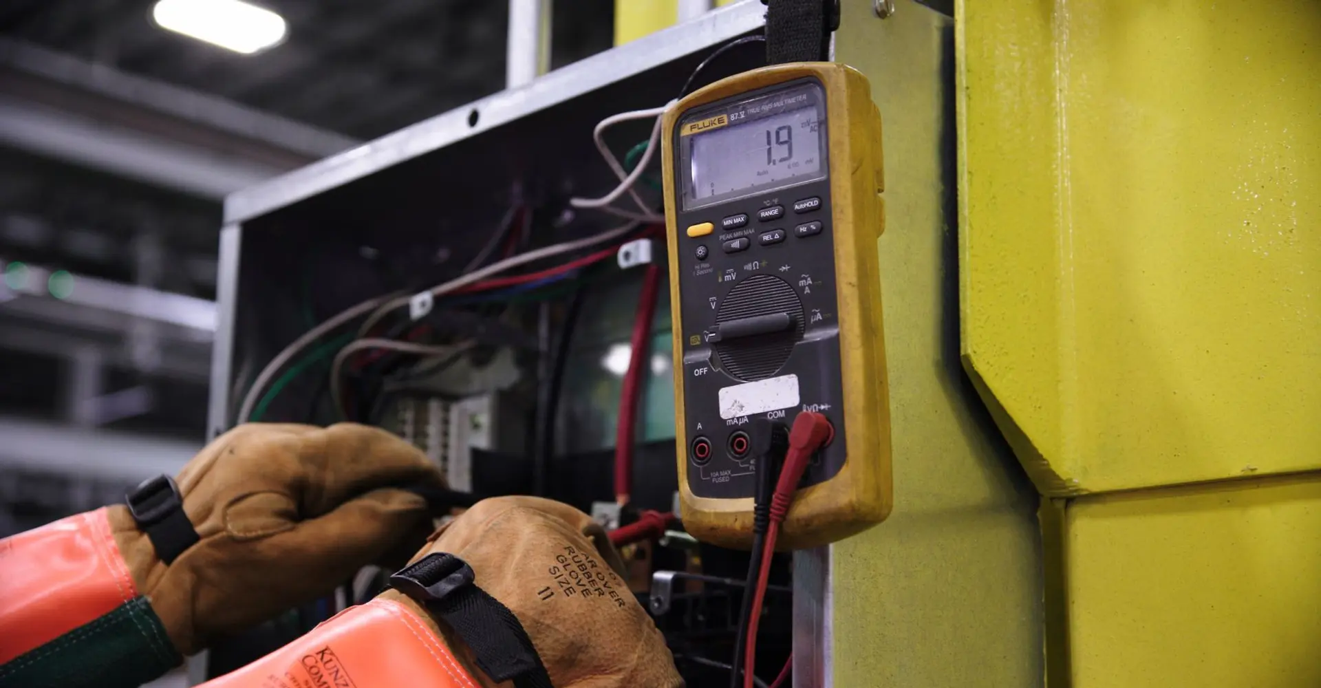 Electrician testing a panel with a multimeter in Terrell TX
